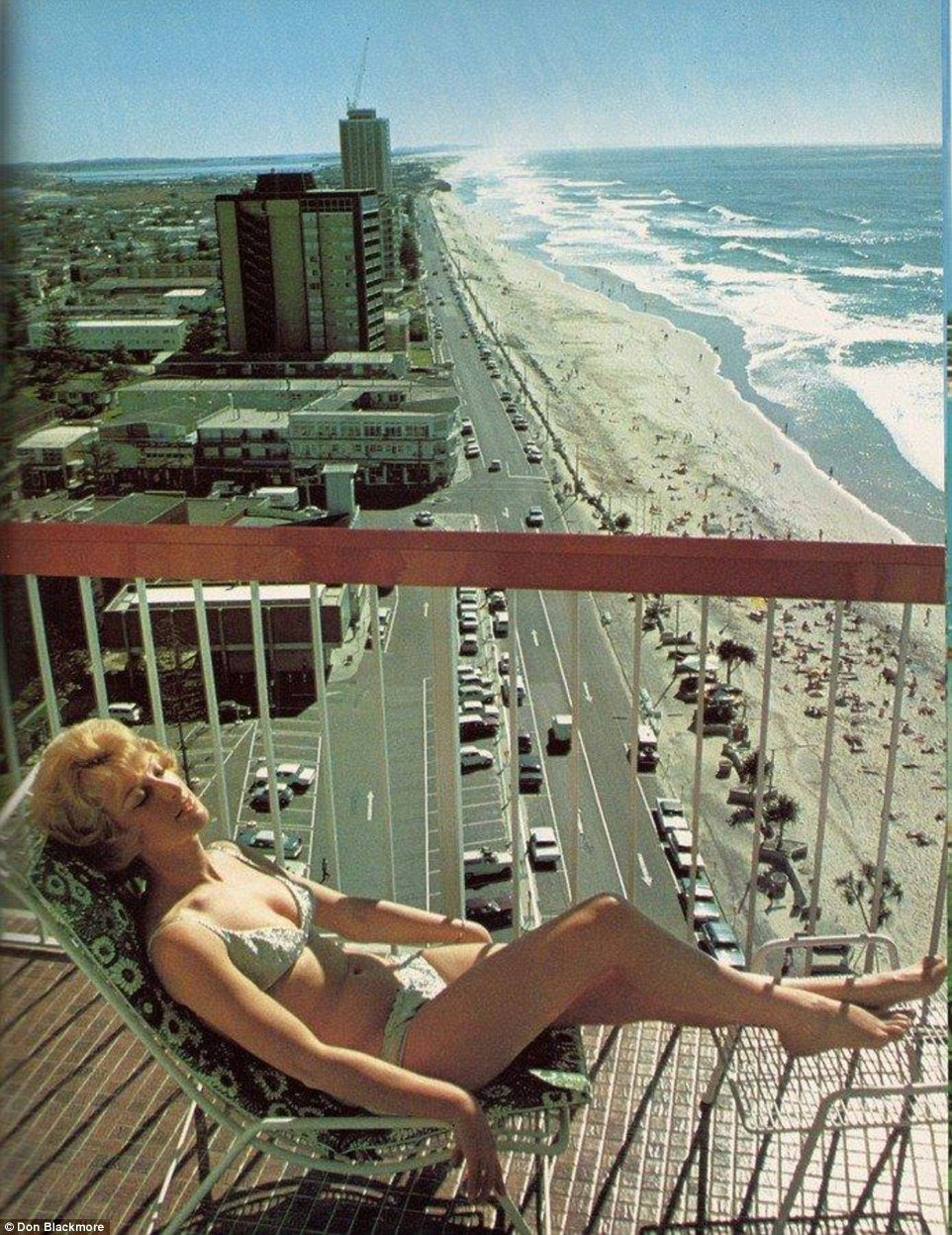 A sunbather on a high-rise balcony above the Gold Coast beachfront